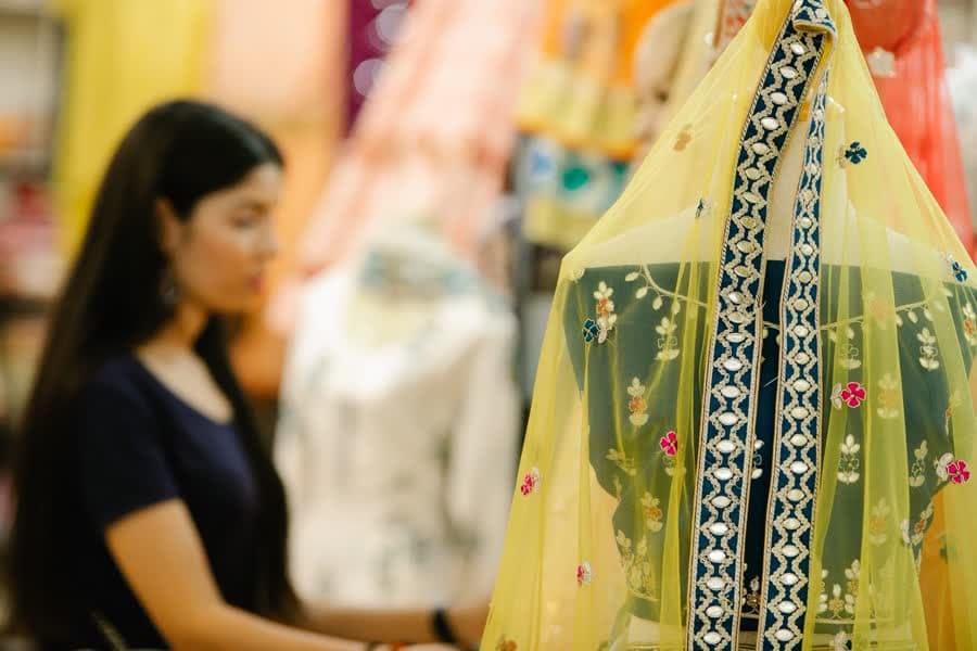 A clothing boutique with traditional Indian garments on display